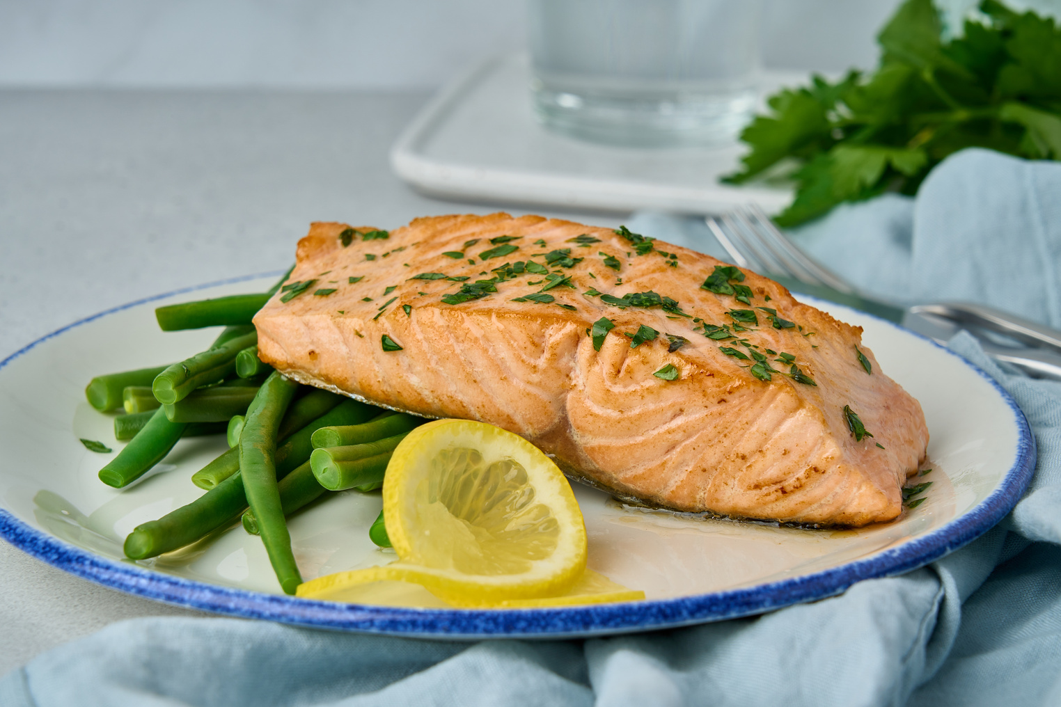 Delicious baked salmon with asparagus, lemon and parsley. Healthy omega3 food