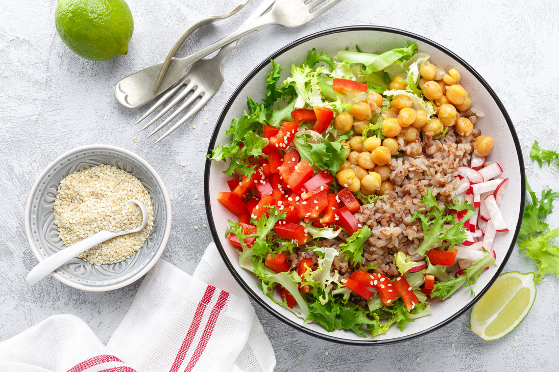 Healthy and delicious bowl with buckwheat and salad of chickpea, fresh pepper and lettuce leaves. Dietary balanced plant-based food. Vegan and vegetarian dish. Top view. Flat lay